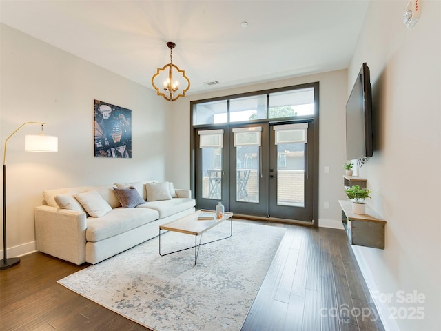 2401 Euclid Ave Unit 207, Charlotte, NC 28203 - living room with dark wood finished floors, baseboards, a chandelier, and french doors
