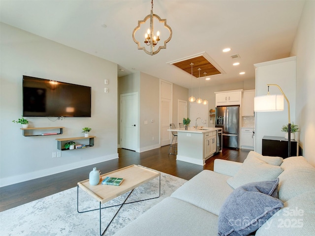 2401 Euclid Ave Unit 207, Charlotte, NC 28203 - living area with a chandelier, dark wood-type flooring, baseboards, and recessed lighting