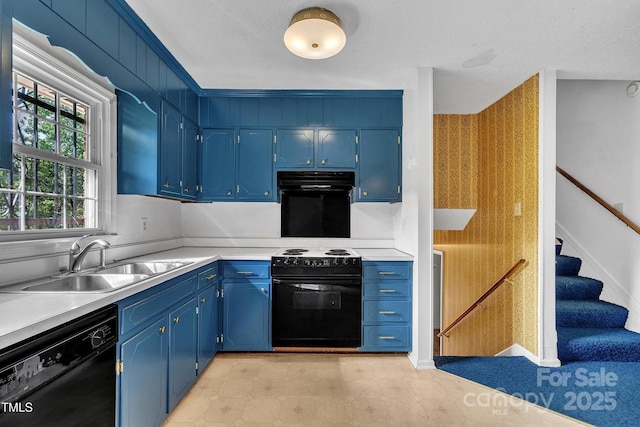kitchen featuring a sink, ventilation hood, blue cabinetry, black appliances, and light countertops