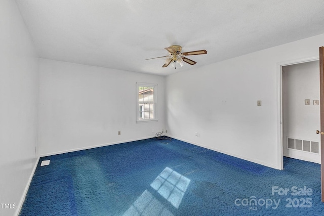 carpeted empty room featuring visible vents, baseboards, and a ceiling fan