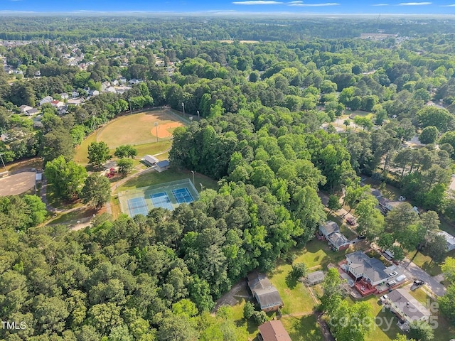 birds eye view of property with a wooded view