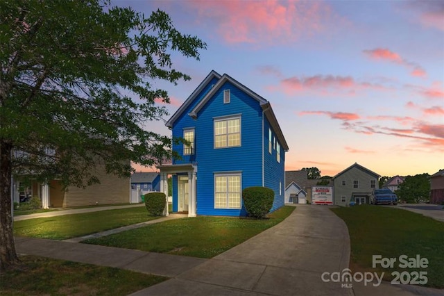 traditional home with driveway and a front lawn