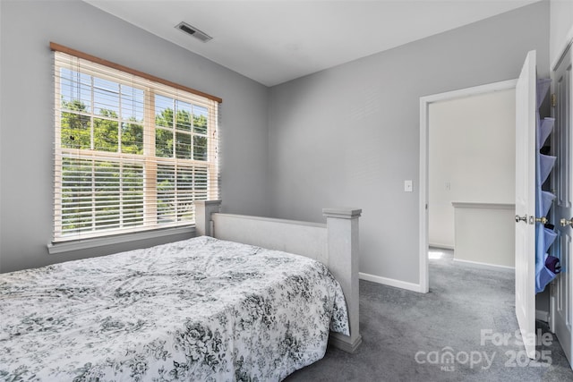 carpeted bedroom featuring baseboards