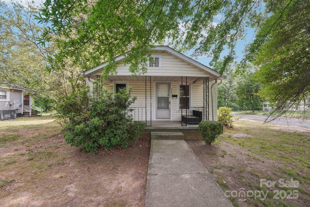 409 Rosemont Ave, Kannapolis, NC 28081 - bungalow-style home featuring a porch and central air condition unit