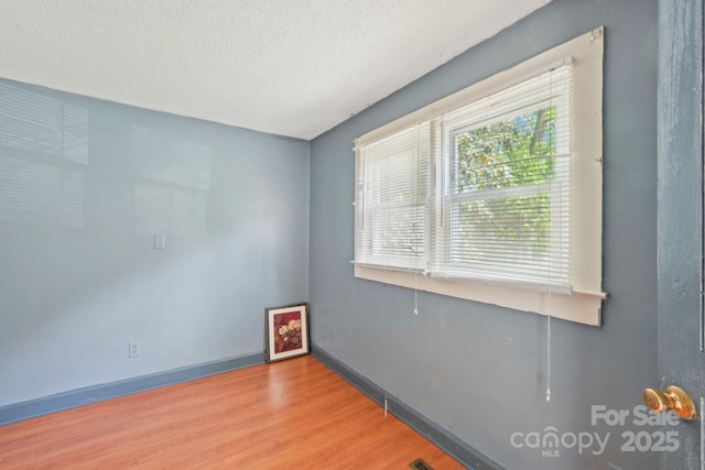 409 Rosemont Ave, Kannapolis, NC 28081 - empty room with a textured ceiling, baseboards, and wood finished floors