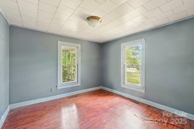 409 Rosemont Ave, Kannapolis, NC 28081 - empty room featuring baseboards, visible vents, and wood finished floors