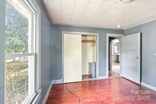 409 Rosemont Ave, Kannapolis, NC 28081 - unfurnished bedroom with ornamental molding, wood finished floors, baseboards, and arched walkways