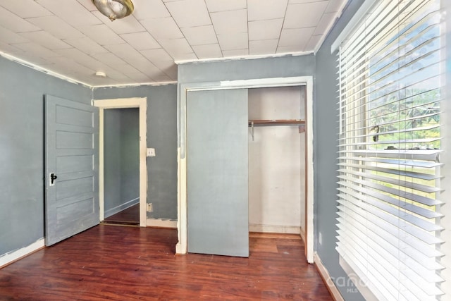 409 Rosemont Ave, Kannapolis, NC 28081 - unfurnished bedroom featuring a closet, wood finished floors, baseboards, and crown molding
