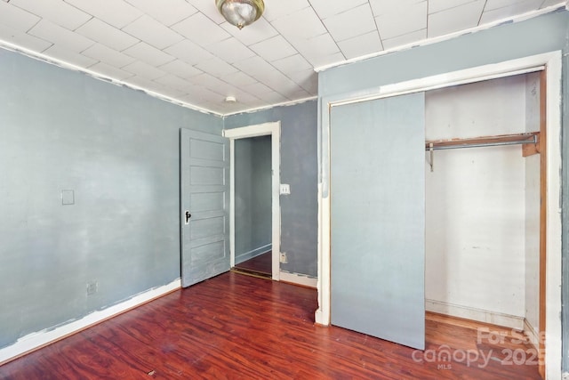 409 Rosemont Ave, Kannapolis, NC 28081 - unfurnished bedroom featuring a closet, baseboards, and wood finished floors