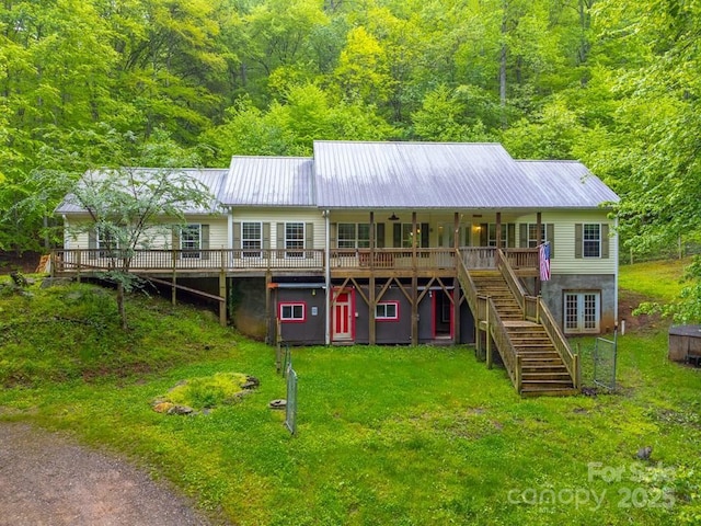 910 Hannah Mountain Rd, Otto, NC 28763 - back of property with a lawn, metal roof, stairway, and a forest view