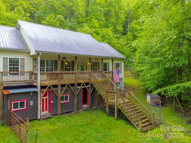 910 Hannah Mountain Rd, Otto, NC 28763 - rear view of house featuring a storage unit, metal roof, a lawn, an outdoor structure, and stairway