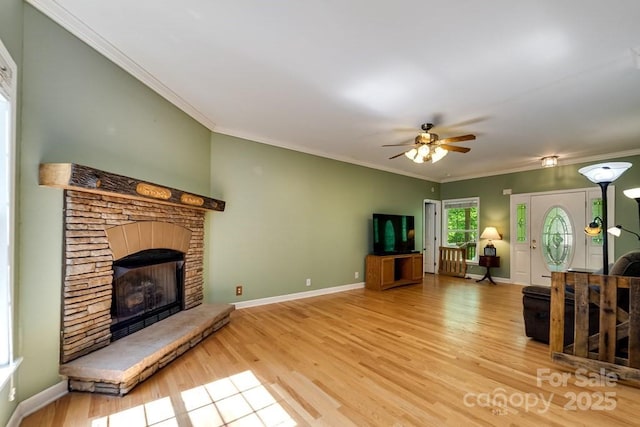 910 Hannah Mountain Rd, Otto, NC 28763 - living area with wood finished floors, a fireplace, crown molding, a ceiling fan, and baseboards