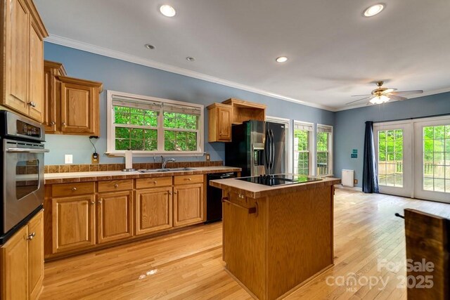 910 Hannah Mountain Rd, Otto, NC 28763 - kitchen featuring plenty of natural light, a center island, and black appliances