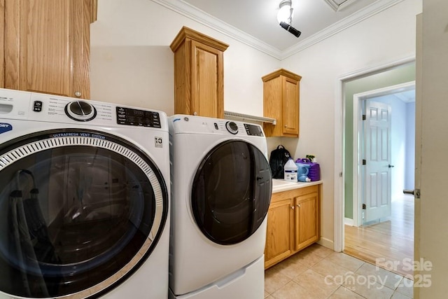 910 Hannah Mountain Rd, Otto, NC 28763 - clothes washing area featuring cabinet space, washer and clothes dryer, light tile patterned floors, and ornamental molding