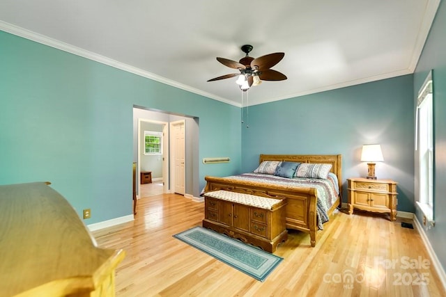 910 Hannah Mountain Rd, Otto, NC 28763 - bedroom featuring light wood-type flooring, visible vents, crown molding, a ceiling fan, and baseboards