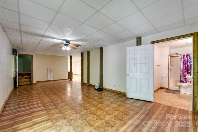 910 Hannah Mountain Rd, Otto, NC 28763 - unfurnished room featuring light wood-type flooring, baseboards, a ceiling fan, and a drop ceiling