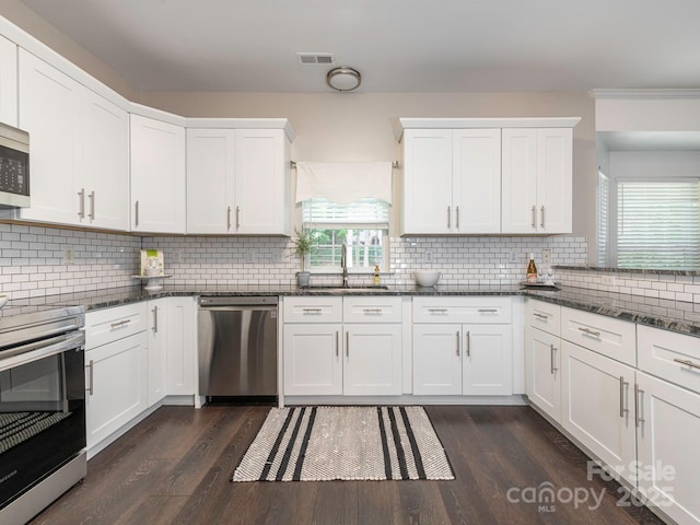 3626 Cole Mill Rd, Charlotte, NC 28270 - kitchen with appliances with stainless steel finishes, a sink, dark wood finished floors, and tasteful backsplash