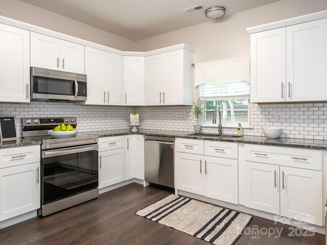 3626 Cole Mill Rd, Charlotte, NC 28270 - kitchen with stainless steel appliances, a sink, dark wood-style floors, white cabinetry, and backsplash