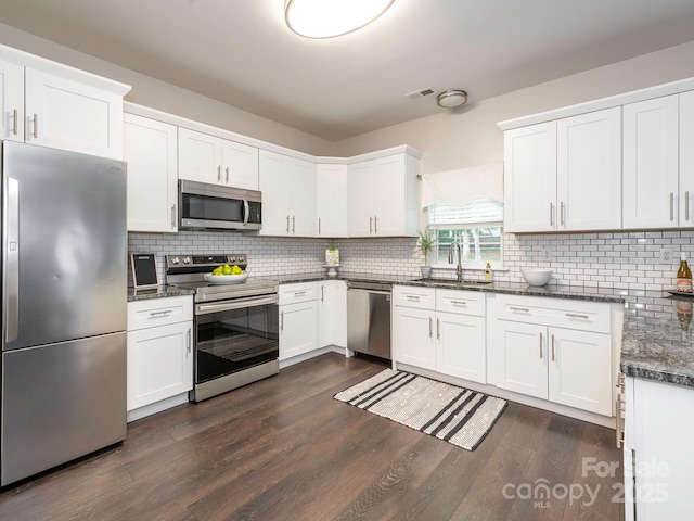 3626 Cole Mill Rd, Charlotte, NC 28270 - kitchen featuring stainless steel appliances, a sink, dark wood-type flooring, and decorative backsplash