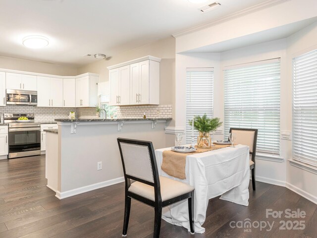 3626 Cole Mill Rd, Charlotte, NC 28270 - dining area featuring dark wood-style floors, crown molding, and baseboards