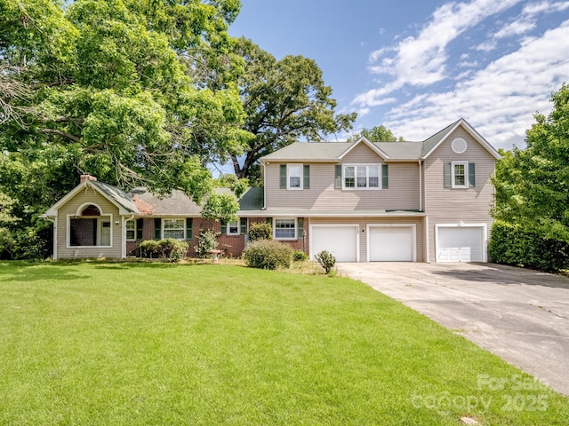 view of front of property featuring a garage, concrete driveway, and a front yard