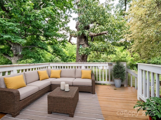 wooden terrace with an outdoor hangout area