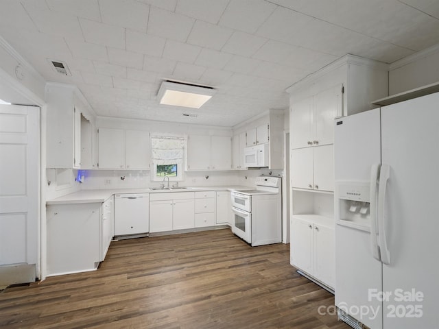 kitchen with white appliances, a sink, dark wood finished floors, and white cabinets