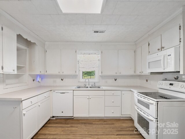 kitchen with white appliances, a sink, white cabinetry, and light wood-type flooring