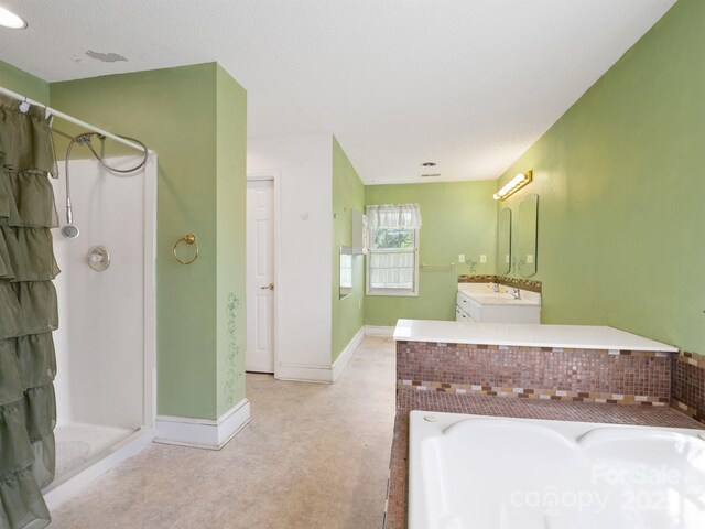 full bath featuring a stall shower, a bath, vanity, and baseboards
