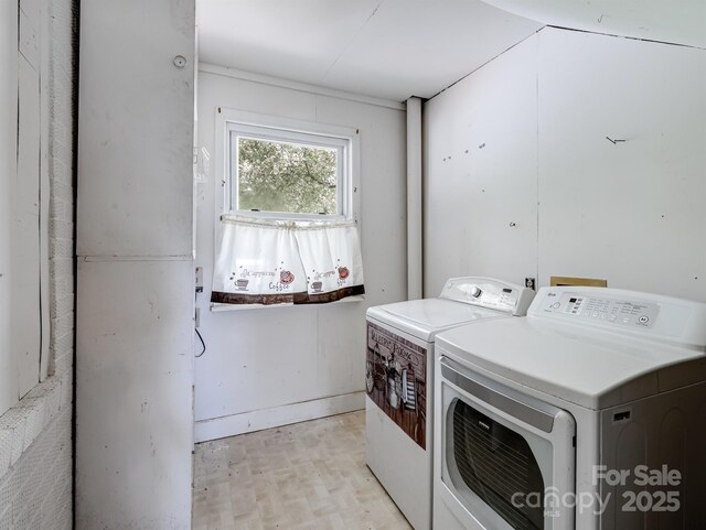 laundry room featuring washing machine and clothes dryer and light wood finished floors