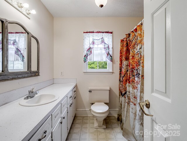 full bathroom with vanity, toilet, baseboards, curtained shower, and tile patterned floors