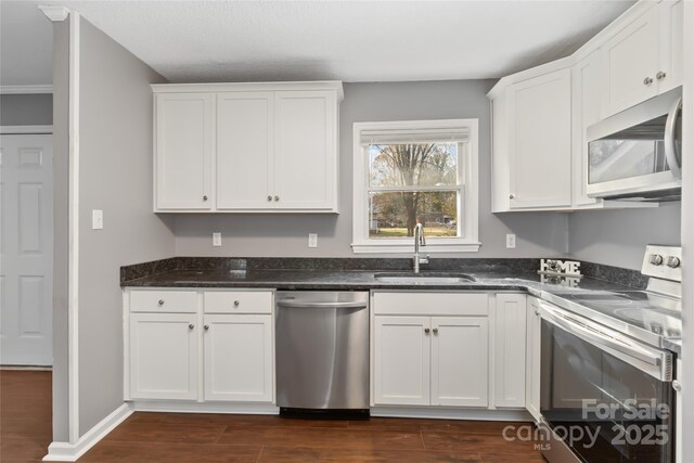1637 Sumner Dr, Rock Hill, SC 29732 - kitchen with a sink, dark stone counters, stainless steel appliances, white cabinets, and dark wood-style floors