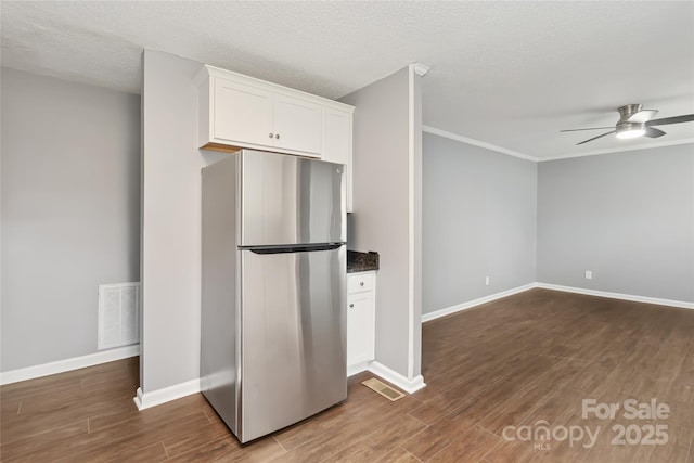 1637 Sumner Dr, Rock Hill, SC 29732 - kitchen with freestanding refrigerator, dark wood finished floors, ceiling fan, visible vents, and white cabinets