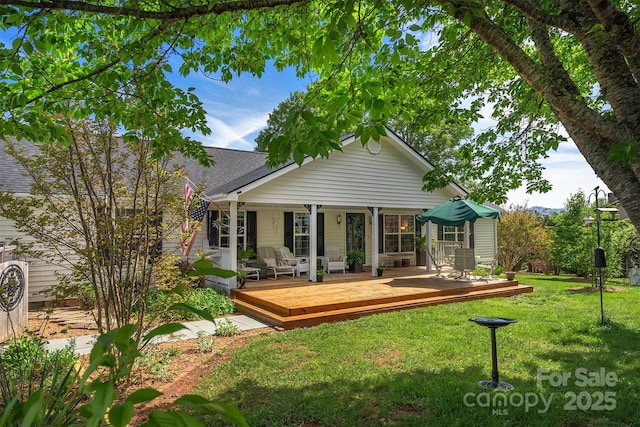 rear view of property featuring a yard