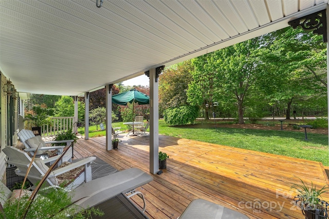wooden deck featuring a yard