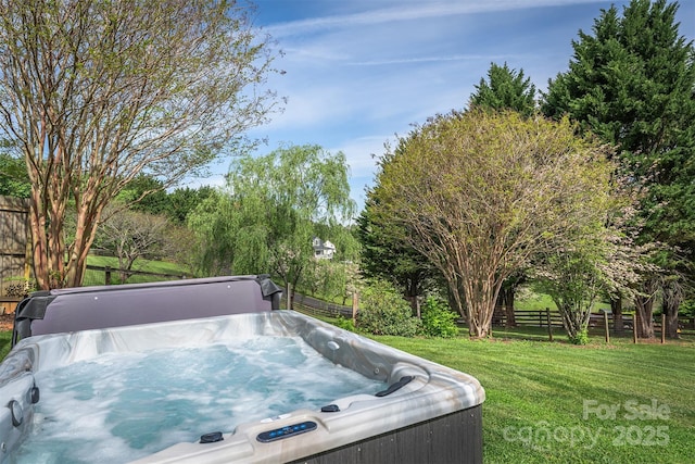exterior space featuring a hot tub and fence