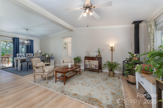 living area featuring ornamental molding, a healthy amount of sunlight, and wood finished floors