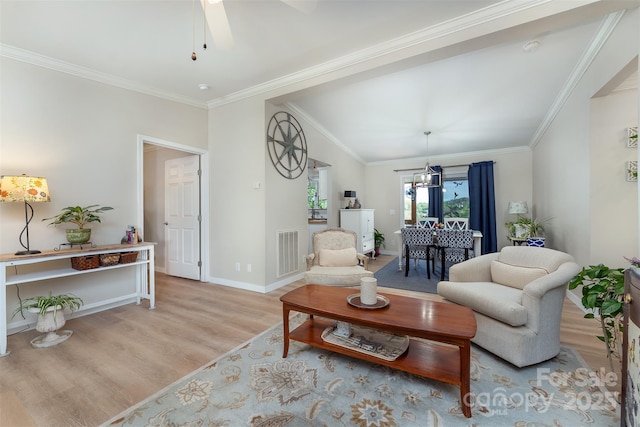 living room with a ceiling fan, baseboards, visible vents, crown molding, and wood finished floors