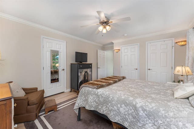 bedroom with a ceiling fan, light carpet, and ornamental molding