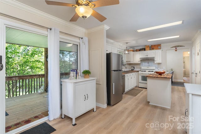 kitchen with freestanding refrigerator, white gas range, light wood-style floors, and white cabinetry