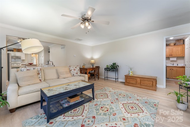 living room with light wood-style flooring and ceiling fan