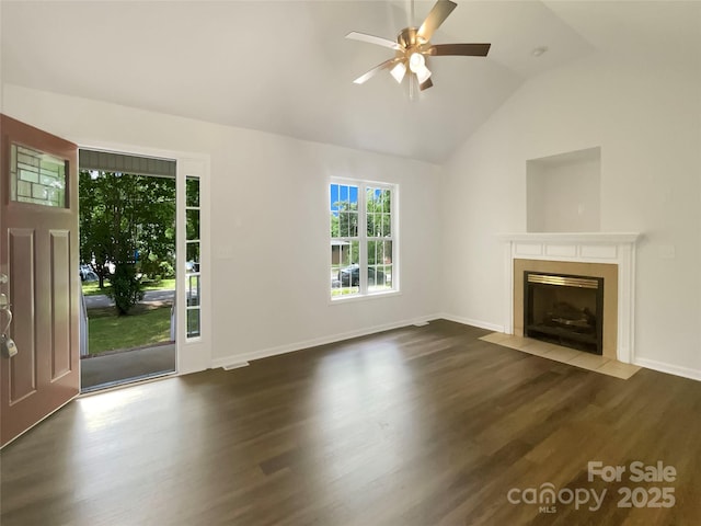 unfurnished living room featuring a ceiling fan, vaulted ceiling, wood finished floors, and a fireplace