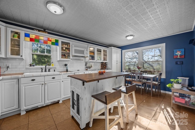 25 Alpine Way, Clyde, NC 28721 - kitchen with butcher block counters, white appliances, decorative backsplash, and white cabinets