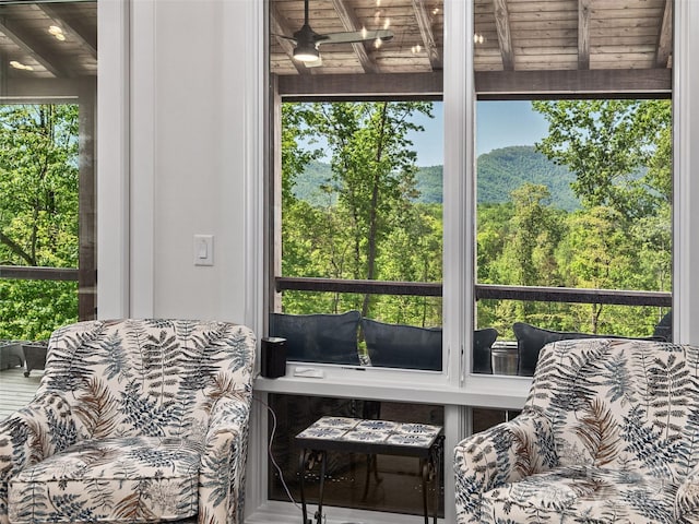 sunroom with beamed ceiling and a healthy amount of sunlight