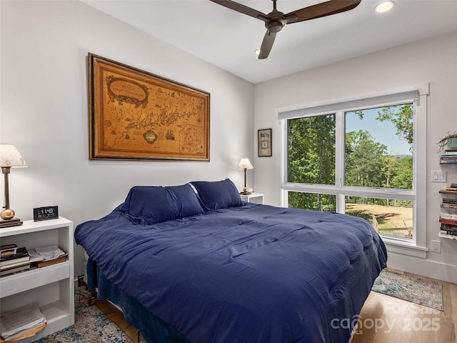 bedroom featuring wood finished floors, baseboards, ceiling fan, and recessed lighting