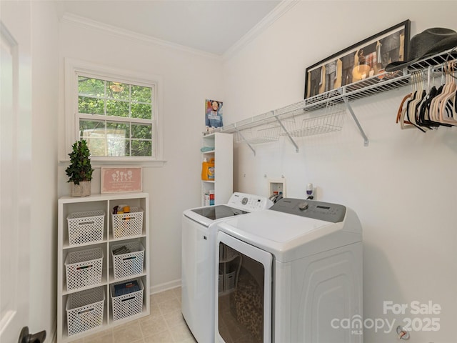 washroom featuring laundry area, baseboards, washing machine and dryer, and ornamental molding