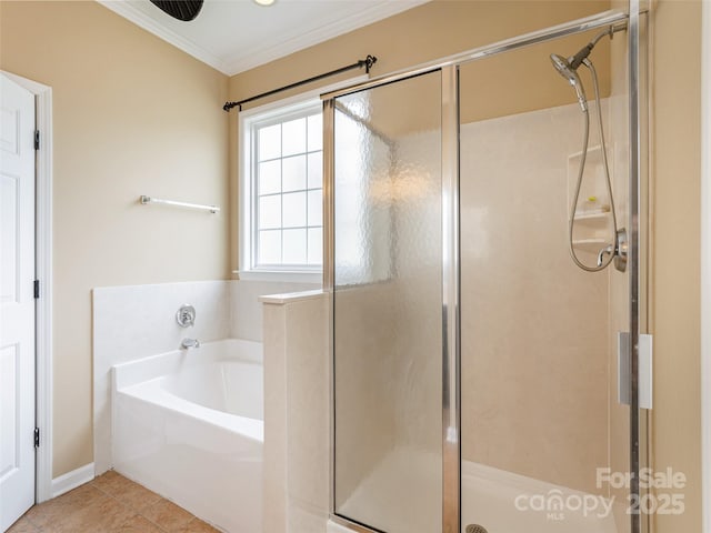 bathroom with a stall shower, crown molding, a garden tub, and tile patterned floors
