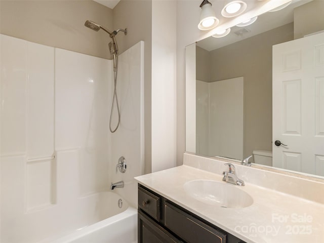full bath featuring vanity, toilet, and bathtub / shower combination