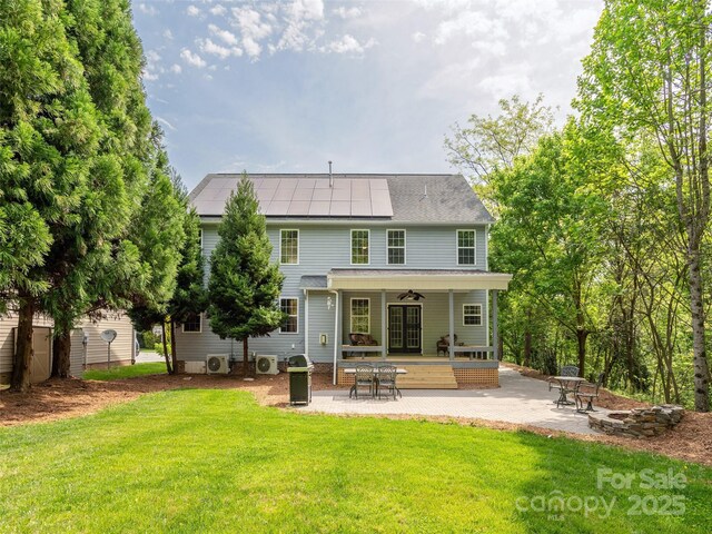 15 Dansford Ln, Arden, NC 28704 - rear view of house featuring a patio, roof mounted solar panels, a ceiling fan, a lawn, and ac unit