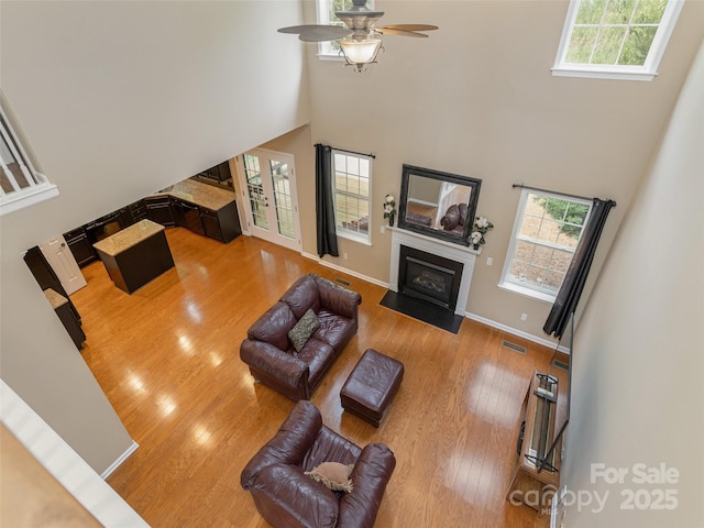 15 Dansford Ln, Arden, NC 28704 - living area with a towering ceiling, healthy amount of natural light, ceiling fan, wood finished floors, and a fireplace with flush hearth